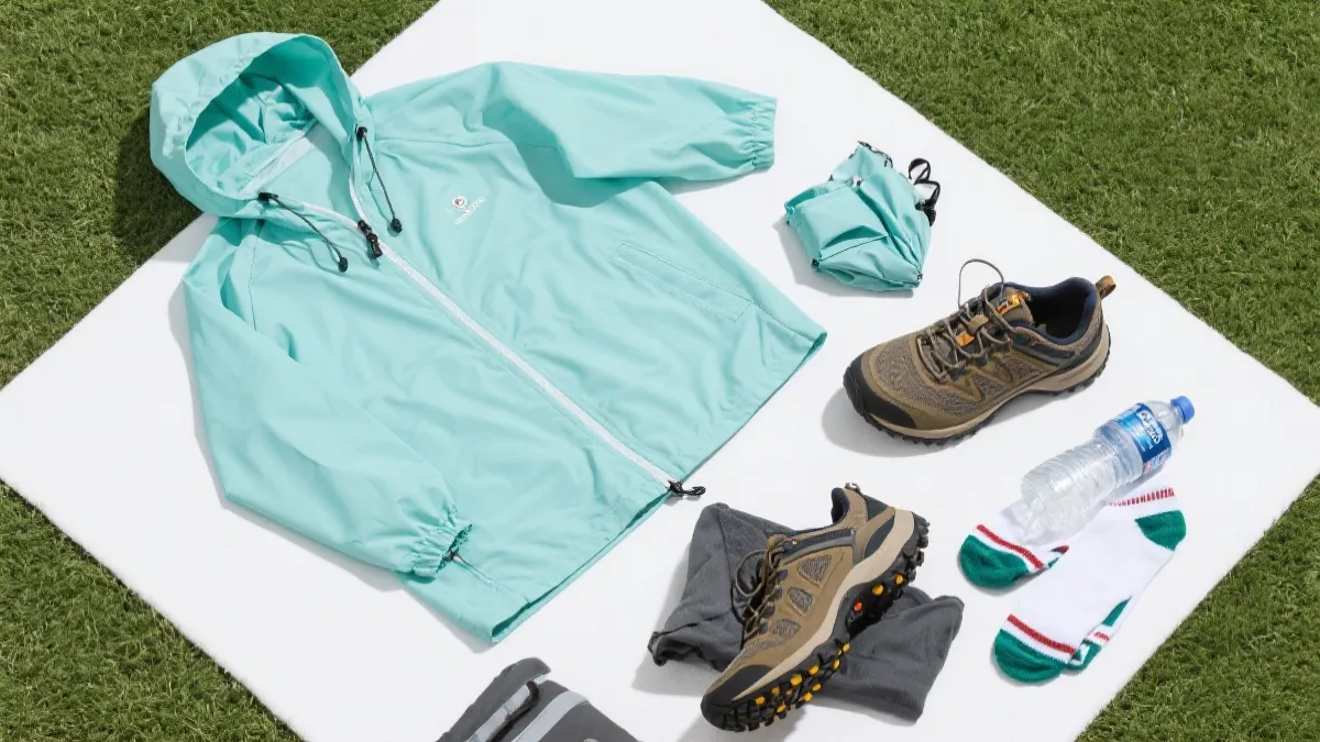 世界杯观赛穿搭平铺：轻薄防风外套、雨衣、水瓶与舒适鞋，适合温哥华6到7月多变天气